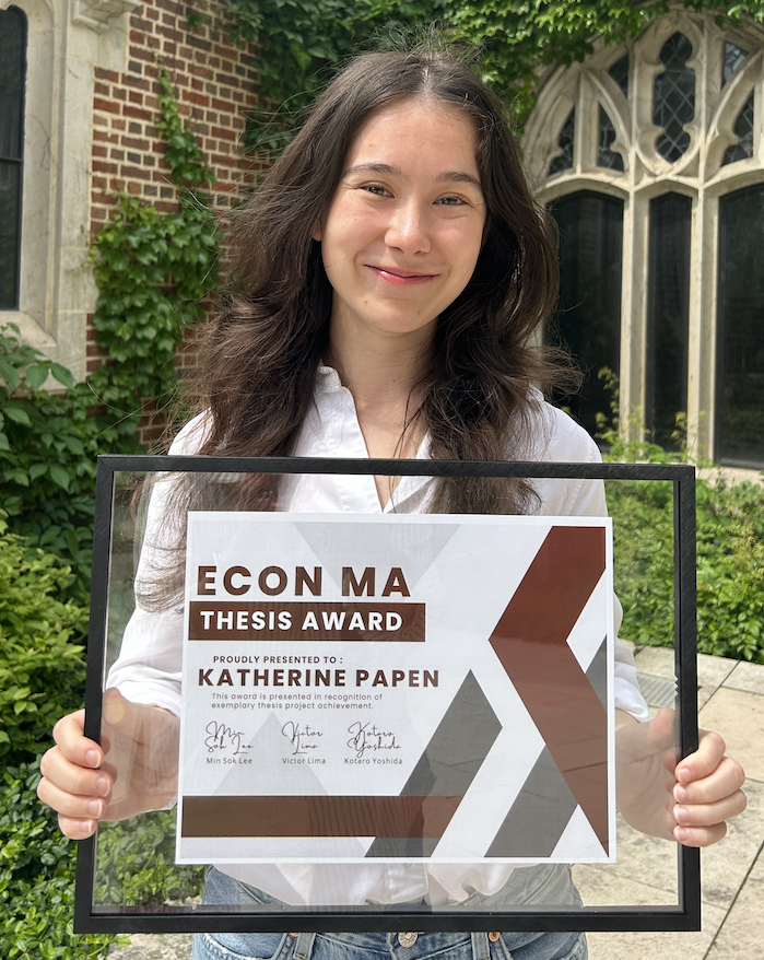 Katherine Papen holding her 2025 Econ MA Thesis Award