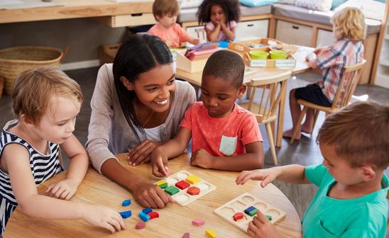 young children and teacher in classroom