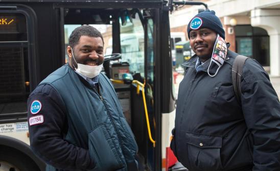 CTA workers standing in front of bus