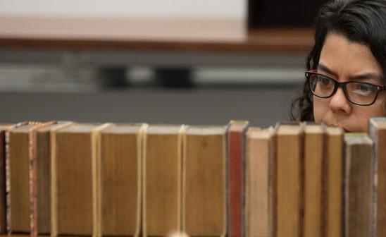 Student browsing library shelves