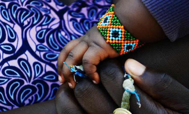 child's hands in mothers' hands