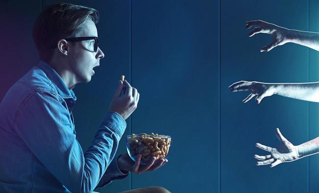 man watching horror movie
