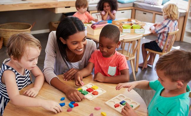 young children and teacher in classroom