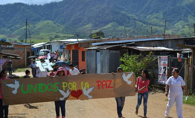 Community members of La Ciudadela in Florencia, Caquetá, Colombia organize a march to support peacebuilding efforts in the Fall of 2015.