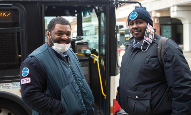 CTA workers standing in front of bus