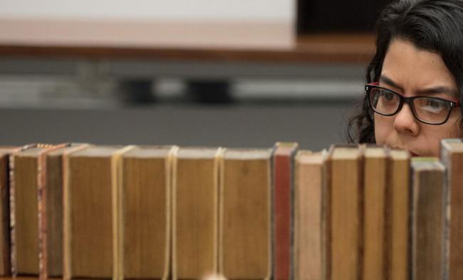 Student browsing library shelves