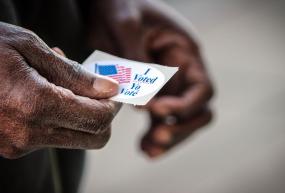 hand holding a voting sticker