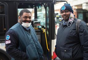 CTA workers standing in front of bus
